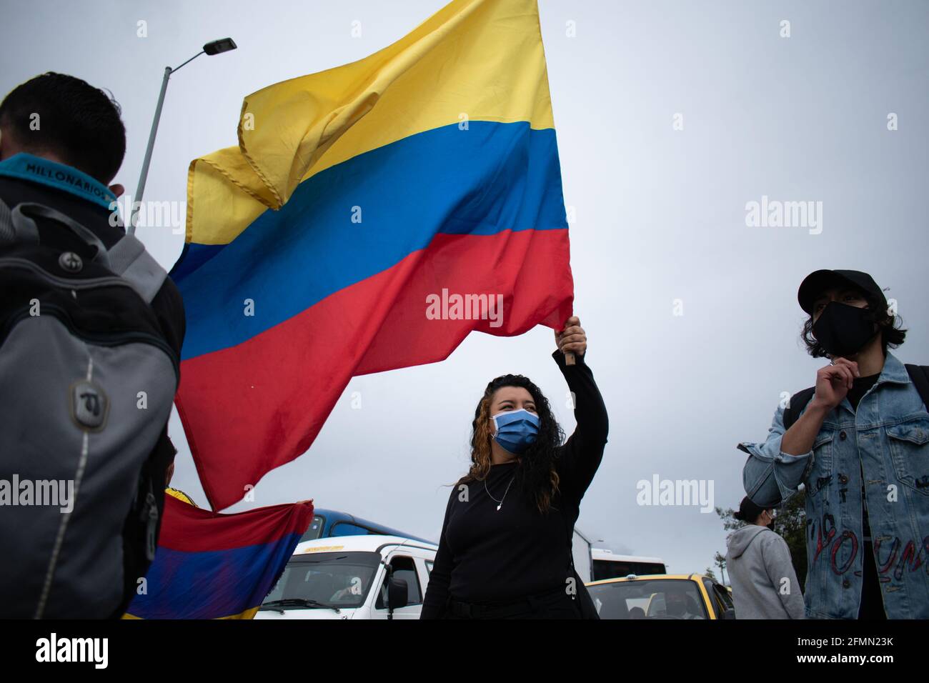 Bogota, Colombia, May 10, 2021, Demonstrators with Colombian flags participate in a protest as Bogota faces its 13 day of anti-government protests against the Health Reform and Police Brutality cases that rise to over 30 dead across the country since the National Strike begun. In Bogota, Colombia on May 10, 2021 Stock Photo