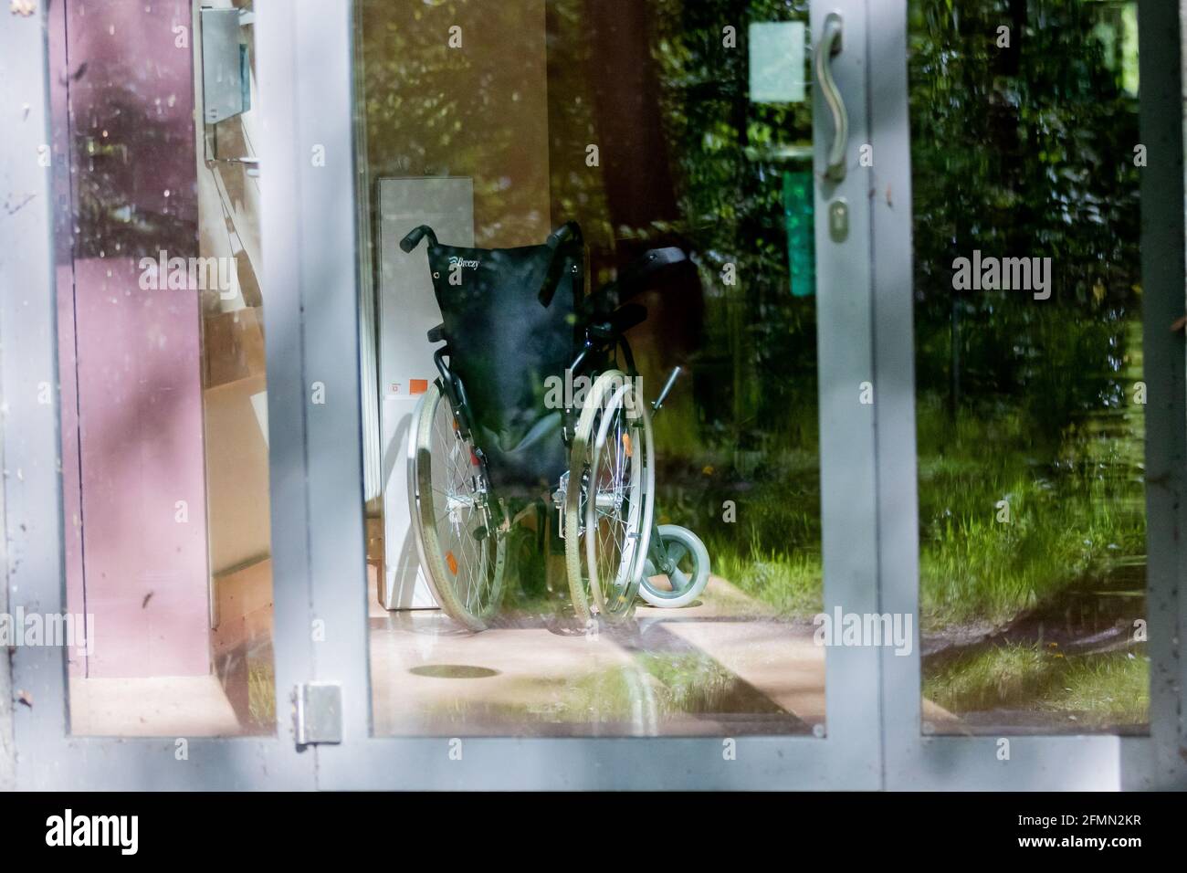 Berlin, Germany. 10th May, 2021. A wheelchair stands in the corridor of the acute geriatrics ward of Havelhöhe Hospital. The International Day of Care is celebrated annually on 12 May. Credit: Christoph Soeder/dpa/Alamy Live News Stock Photo