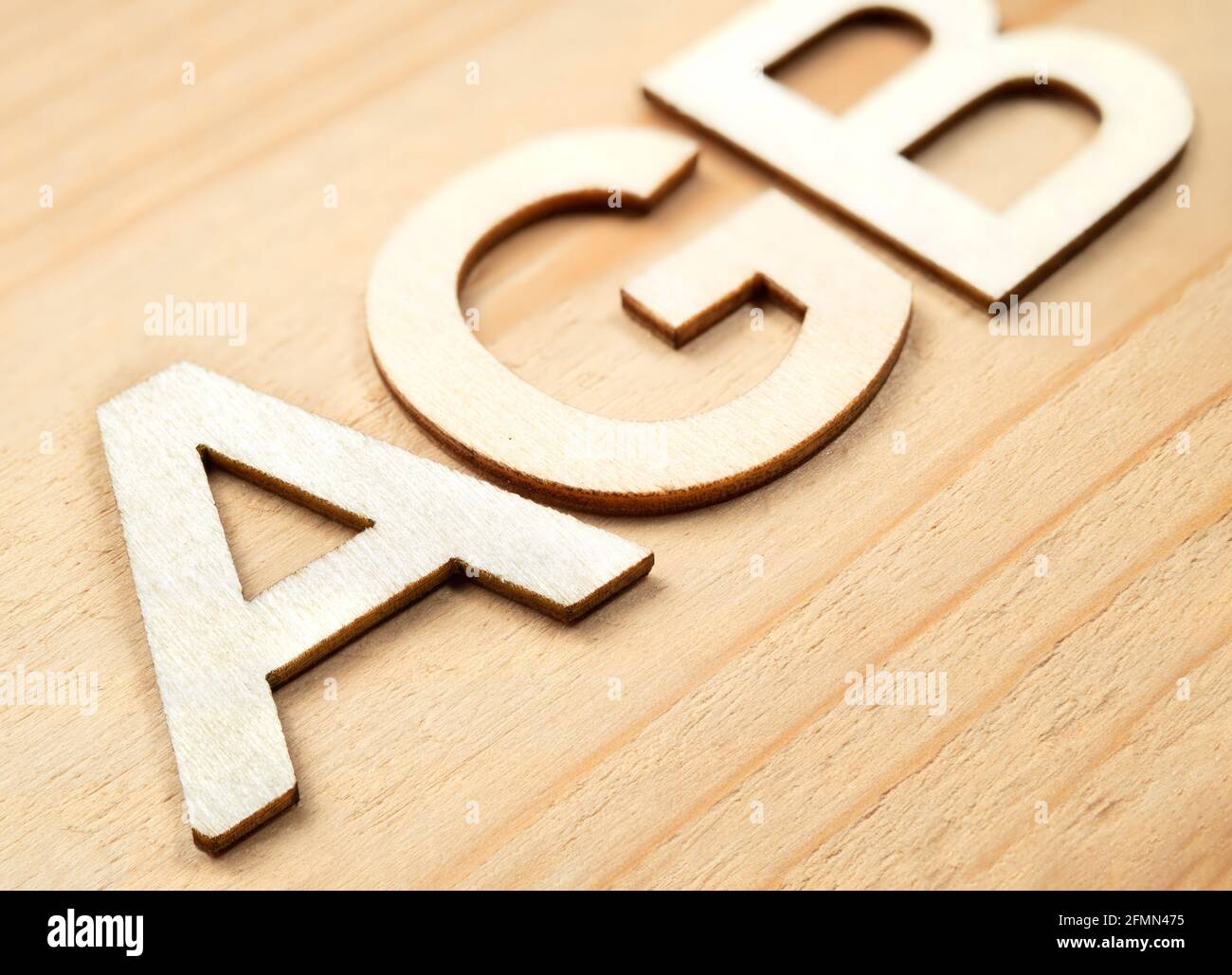 AGB wood letters. Selective focus on front with defocused letters to the back. German acronym or abbreviation for: AGB - Allgemeine Geschäftsbedingung Stock Photo