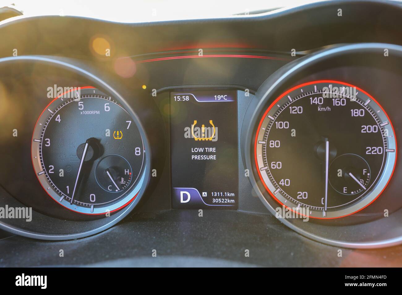 Low tire pressure error sign. Warning lights flash on the car dashboard