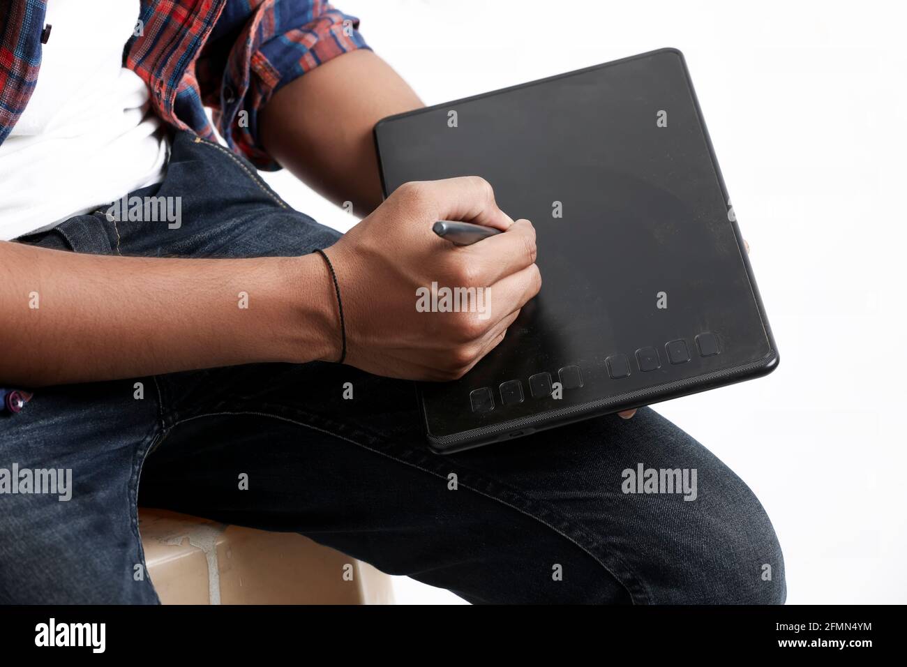 Professional designer using graphic tablet connected to smartphone with digital pen. Stock Photo