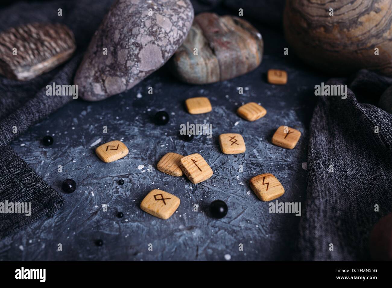 Fortune telling on wooden runes among stones. Gloomy and mysterious witch  table Stock Photo - Alamy