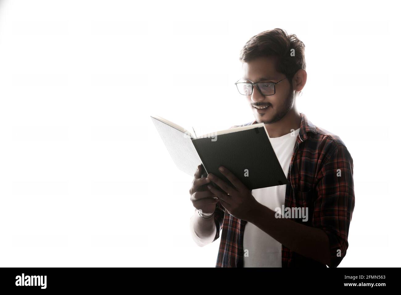 Indian college student reading book on white background Stock Photo - Alamy