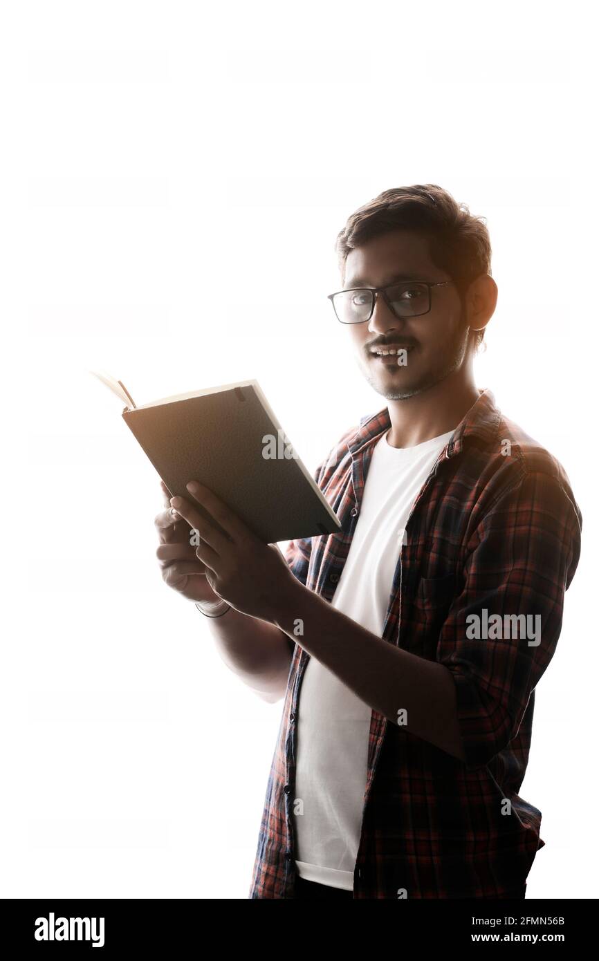 Indian college student reading book on white background Stock Photo - Alamy