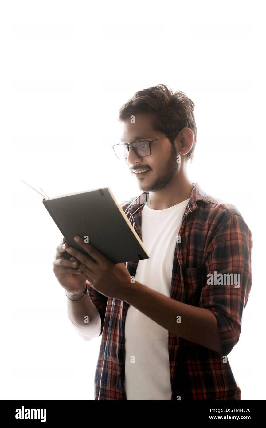 Indian college student reading book on white background Stock Photo - Alamy