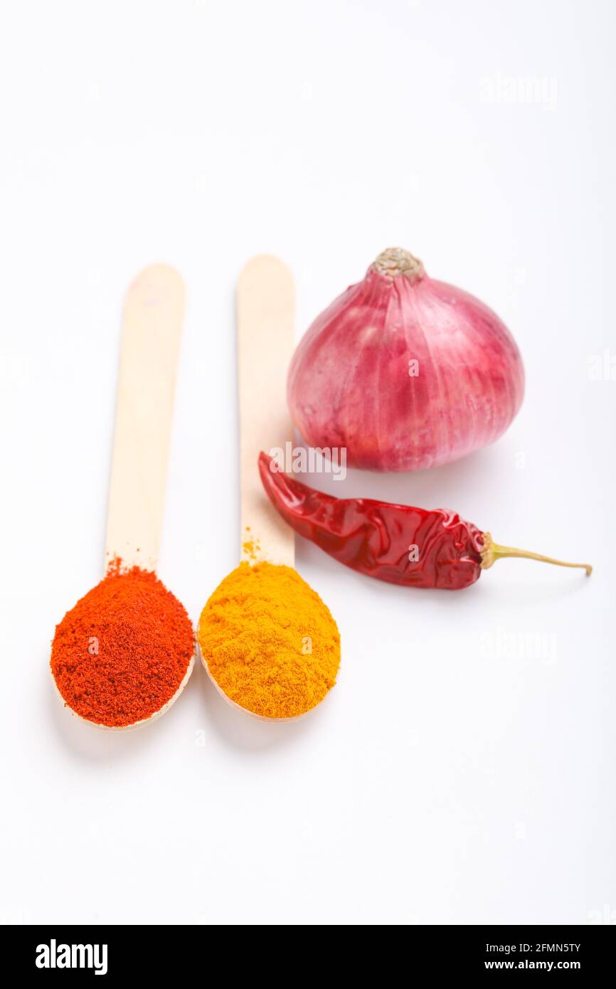 Spices ingredient Onion,Red chili powder and turmeric powder on white