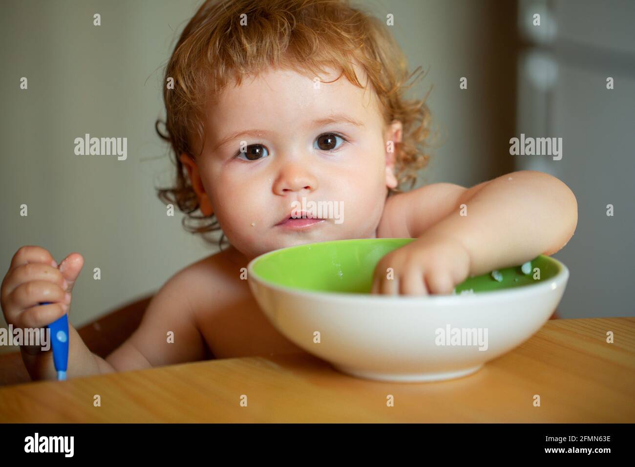 Portrait of funny little baby boy eating from plate holding spoon closeup Stock Photo - Alamy Portrait of funny little baby boy eating from plate holding spoon closeup Stock Photo - Alamy