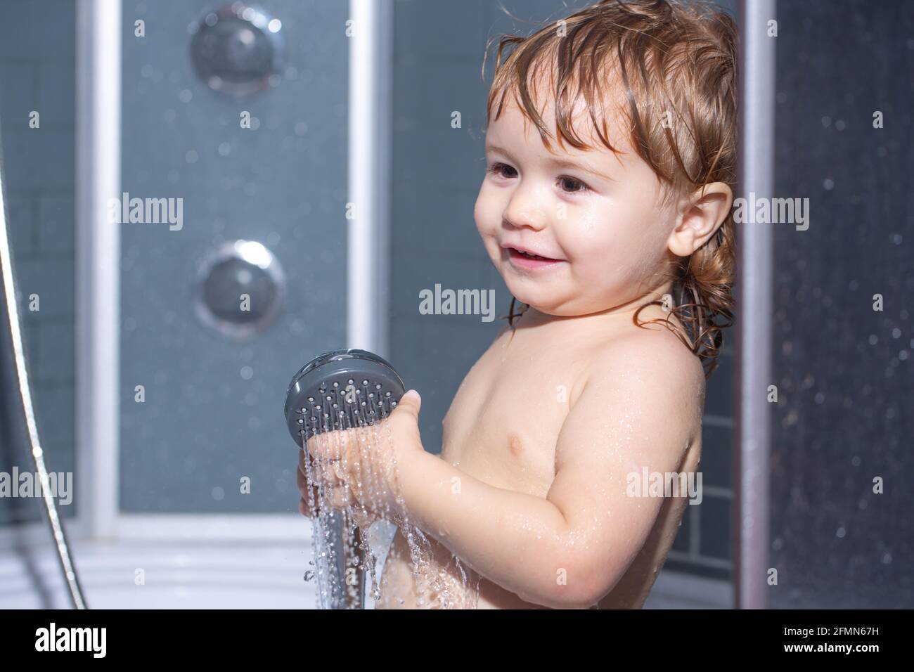 Children healthcare. Baby showering. Portrait of kid bathing in a bath