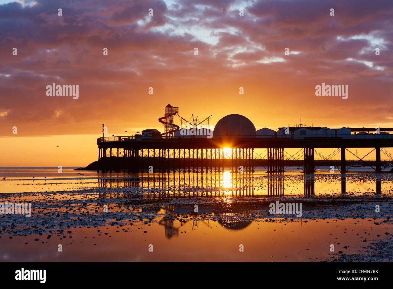 Herne Bay, Kent, UK. 11th May 2021: UK Weather. Sunrise at Herne Bay pier. With the country coming out of lockdown and the summer approaching the coastal resorts are expecting an influx of tourists as people holiday in the UK. The weather is set to be warm with a mixture of sunshine and showers for the next few days. Credit: Alan Payton/Alamy Live News Stock Photo