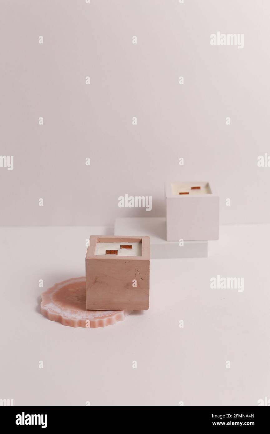 scented candles on off white background in rock holder Stock Photo - Alamy