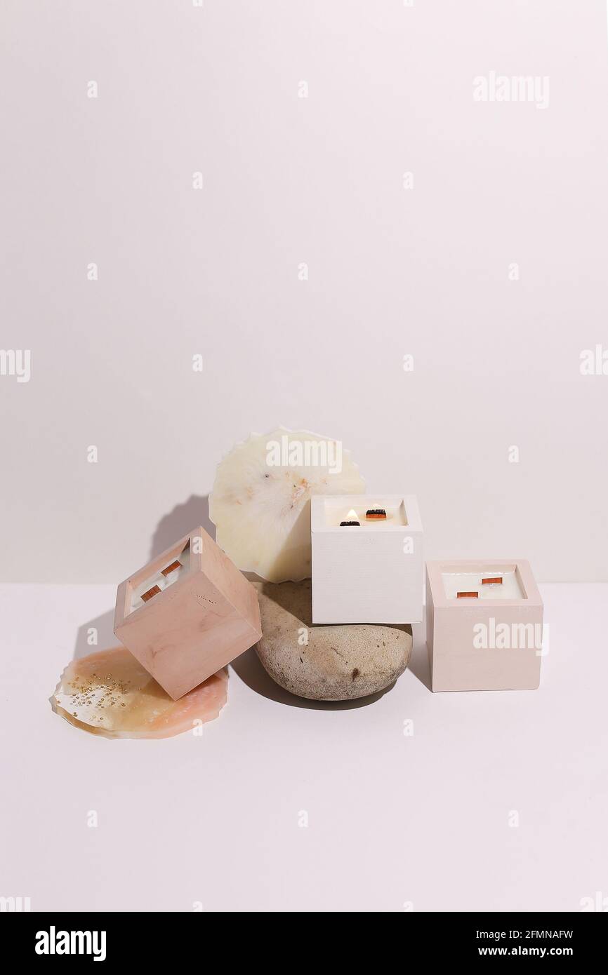 scented candles on off white background in rock holder Stock Photo - Alamy