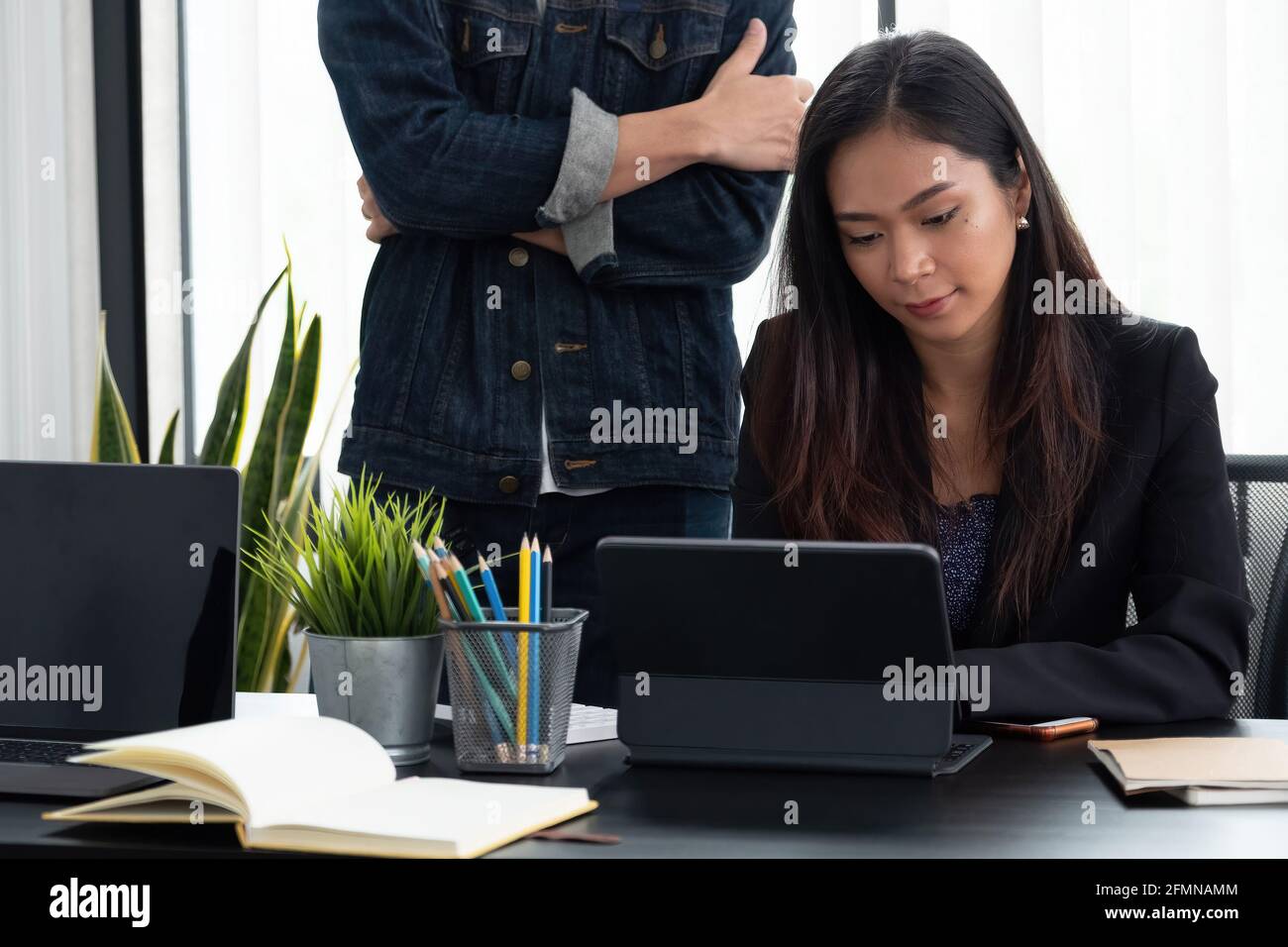 Business adviser analyzing financial figures denoting the progress in the work of the company. Stock Photo