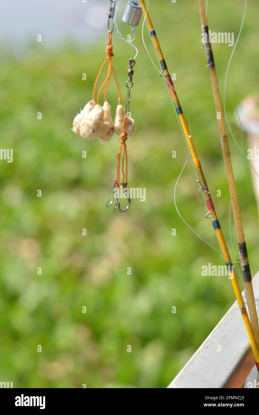 Close up of  some fishing hook and fishing baits with string and rod, selective focusing Stock Photo