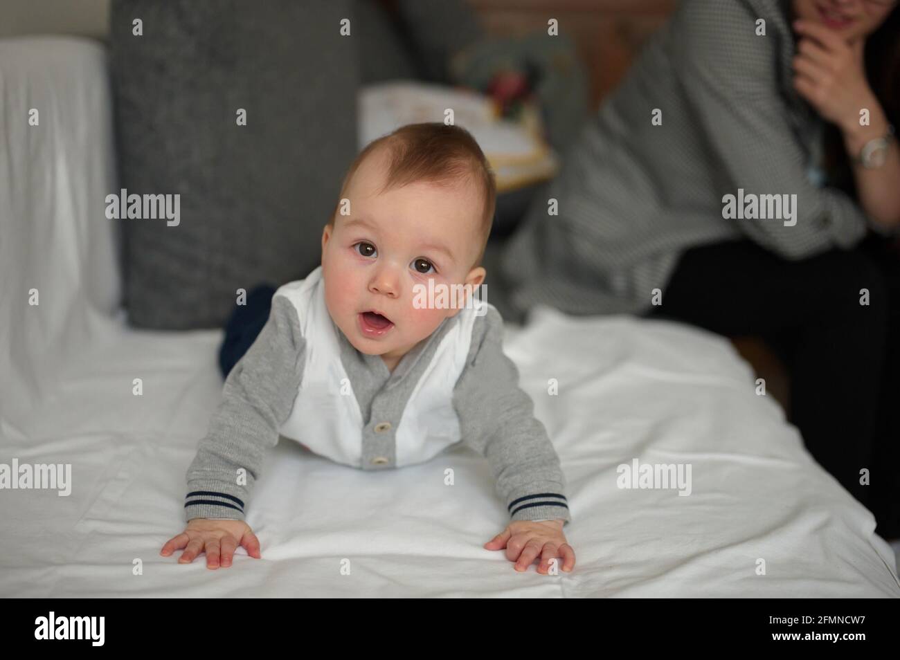 Portrait of cute little baby relaxing on a sofa Stock Photo Alamy