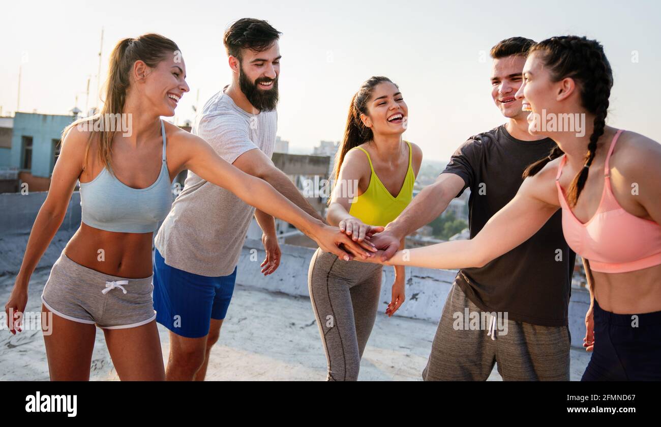 Portrait of smiling fit happy people doing power fitness exercise Stock Photo