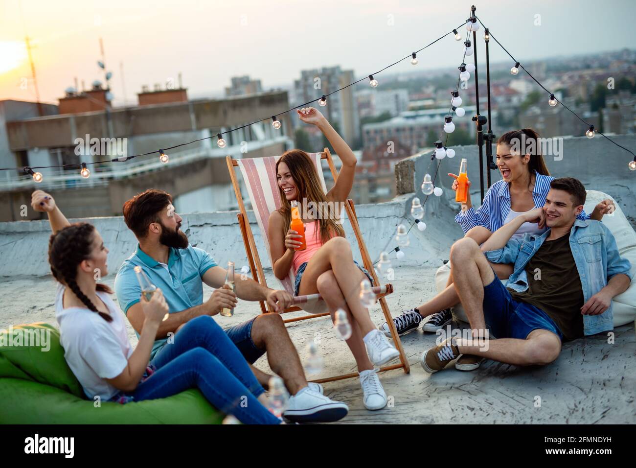 Fun Rooftop Party Group of happy friends having fun at rooftop party Stock Photo - Alamy