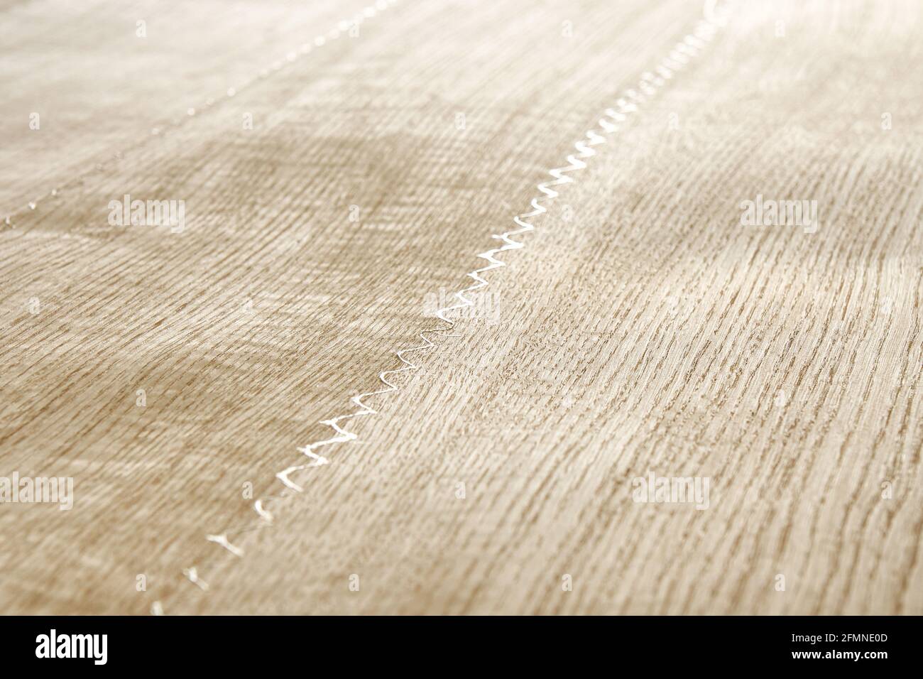Oak texture as background. Spliced oak veneer with glue thread for furniture manufacturing closeup Stock Photo
