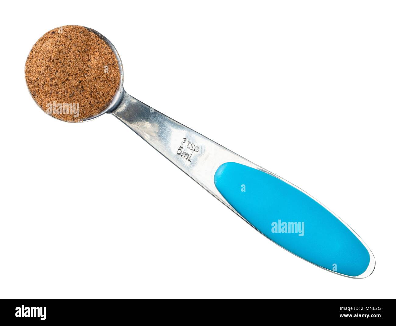top view of nutmeg powder in measuring teaspoon cutout on white