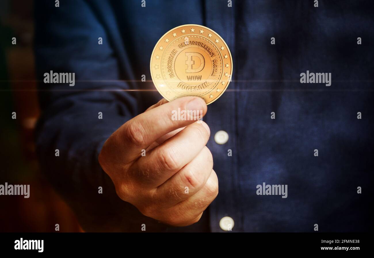 Dogecoin WOW cryptocurrency symbol golden coin in hand abstract concept  Stock Photo - Alamy