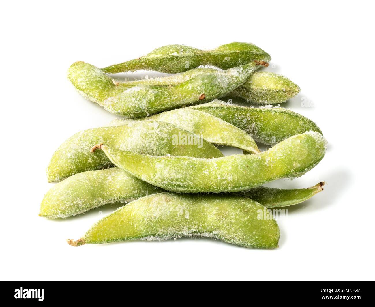 handful of frozen Edamame unripe soybeans in pod closeup on white