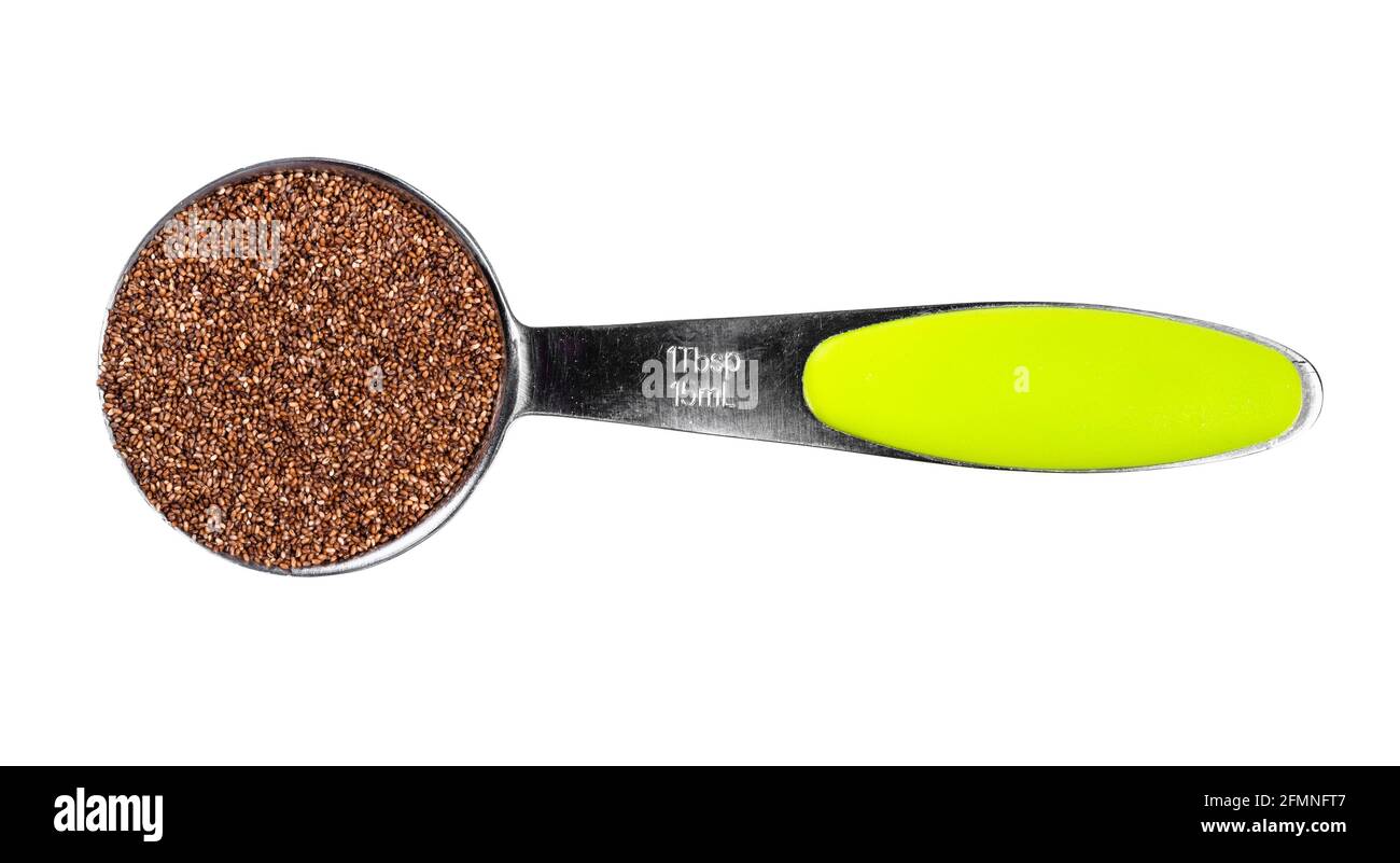 top view of wholegrain teff seeds in measuring tablespoon cutout on white background Stock Photo