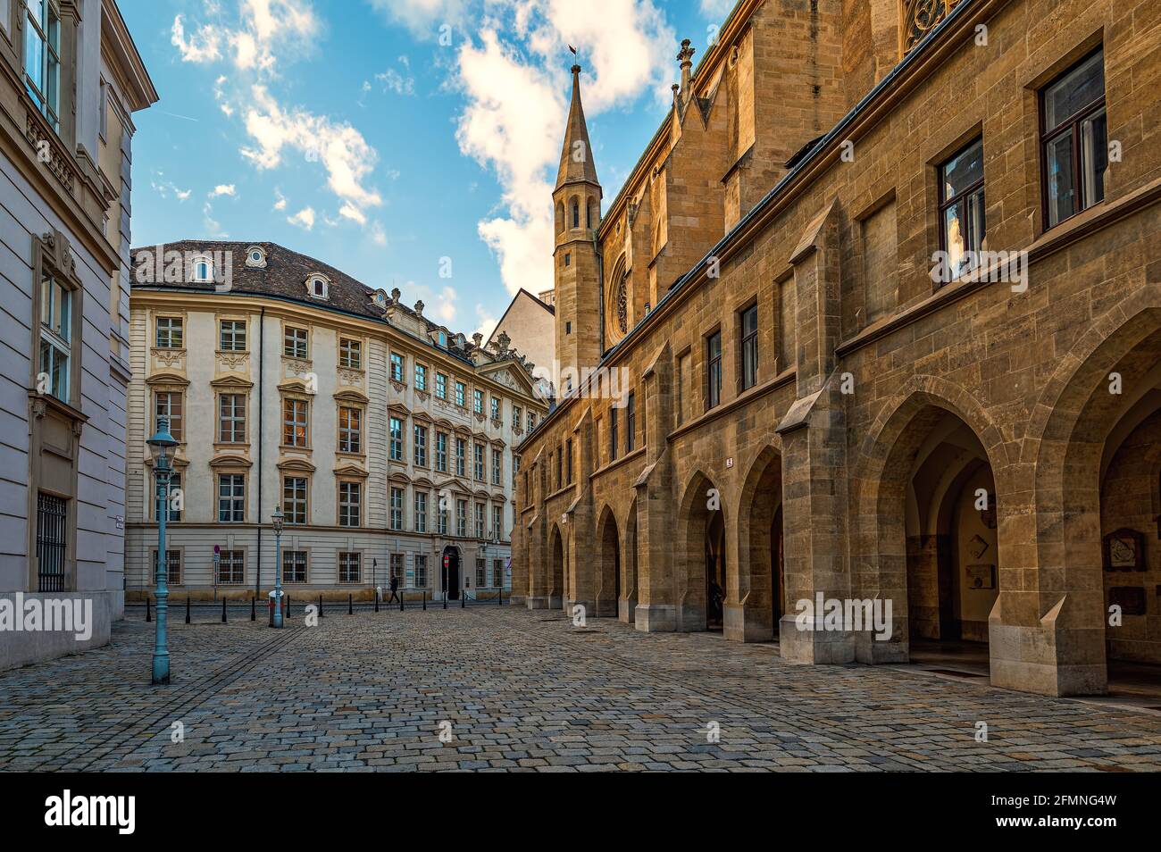 View of famous Minoritenkirche and old cobblestone street in old city of Vienna, Austria. Stock Photo