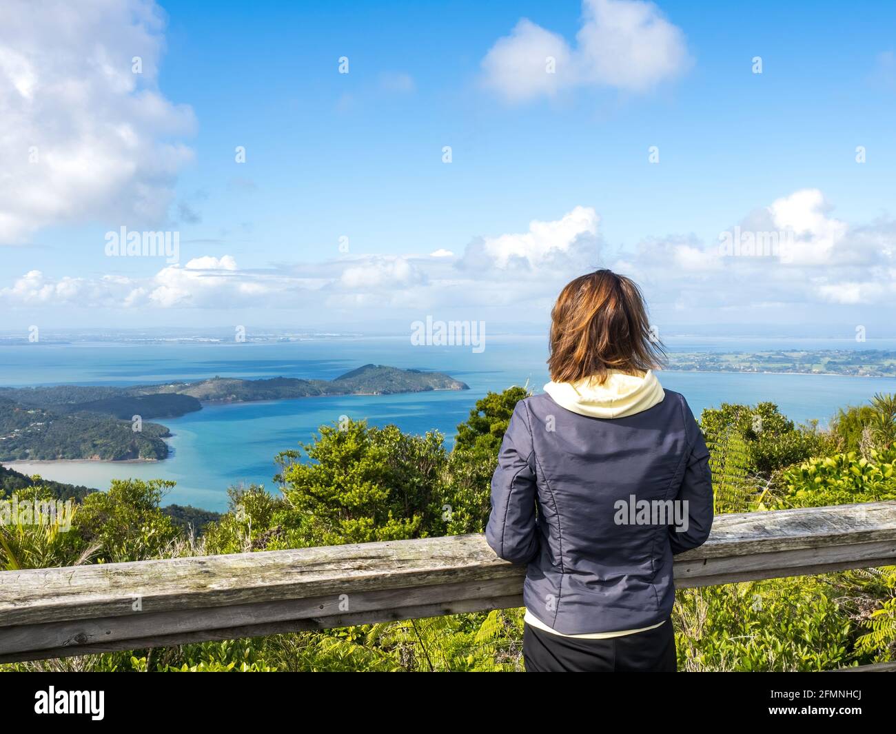 AUCKLAND, NEW ZEALAND - Apr 27, 2021: Woman at Mt Donald McLean lookout observing Manukau Inlet Stock Photo