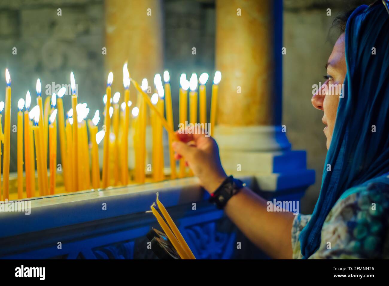 Jerusalem, Israel April 30, 2021 View of a pilgrim lighting a candle