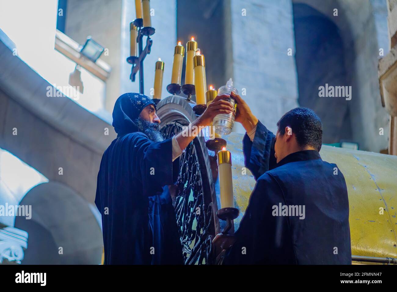 Jerusalem, Israel April 30, 2021 Coptic priests lighting oil candles