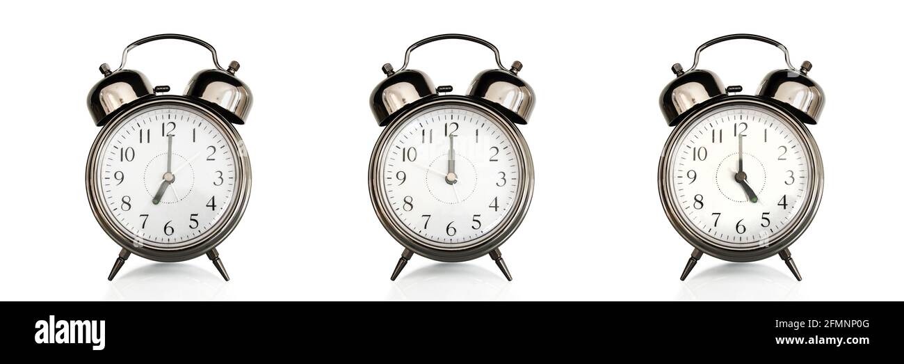 Old vintage alarm clocks at different time of the days isolated on panoramic white background. Morning, noon,afternoon,evening concept Stock Photo