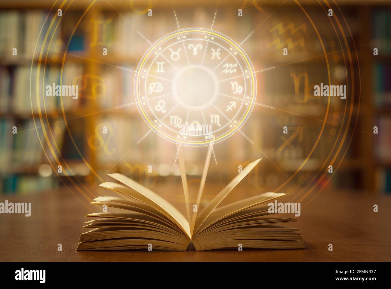 Horoscope astrology, Zodiac sign and constellation study for foretell and fortune telling education course concept with horoscopic wheel over old book Stock Photo