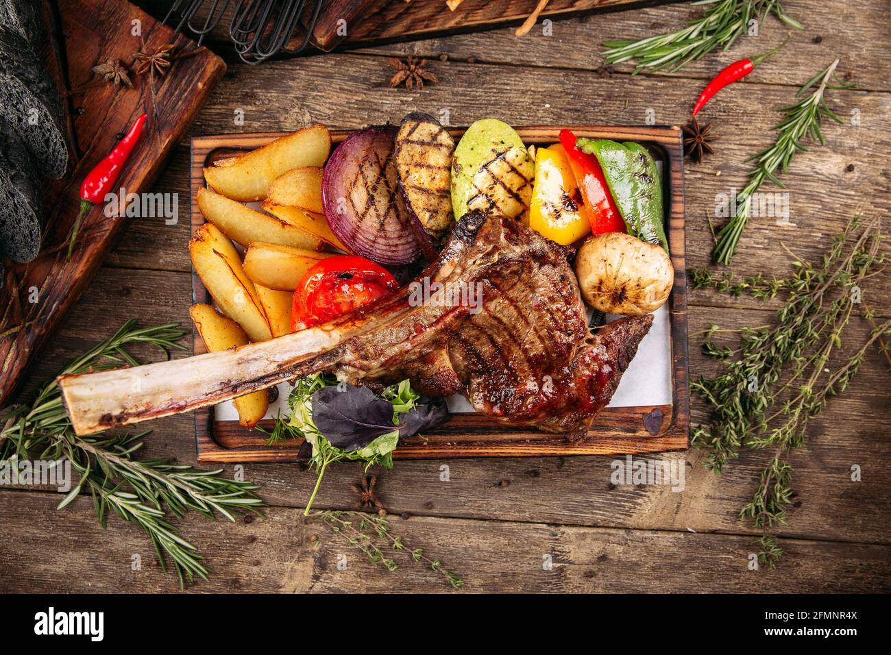 Grilled beef tomahawk steak with vegetables Stock Photo
