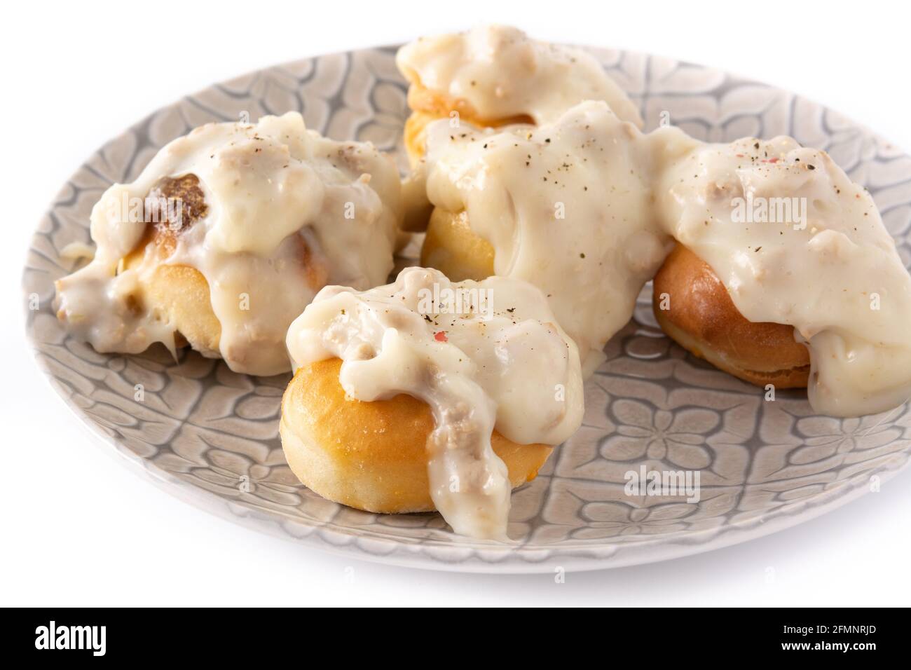 Traditional American biscuits and gravy for breakfast isolated on white background Stock Photo