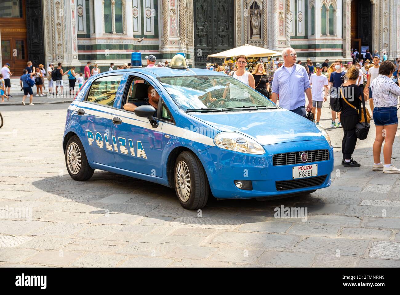 FLORENCE, ITALY - Aug 24, 2020: Florence, Tuscany/Italy - 24.08.2020: A blue Italian police car in the midst of tourists in Florence ensuring safety. Stock Photo