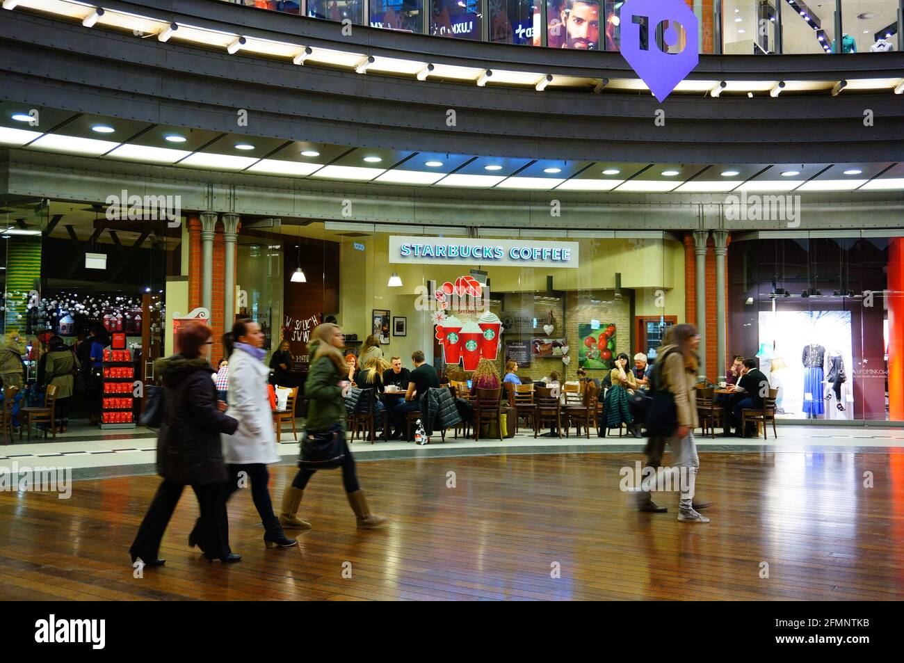 POZNAN, POLAND - Dec 01, 2013: Walking people in the Stary Browar shopping mall. Stock Photo