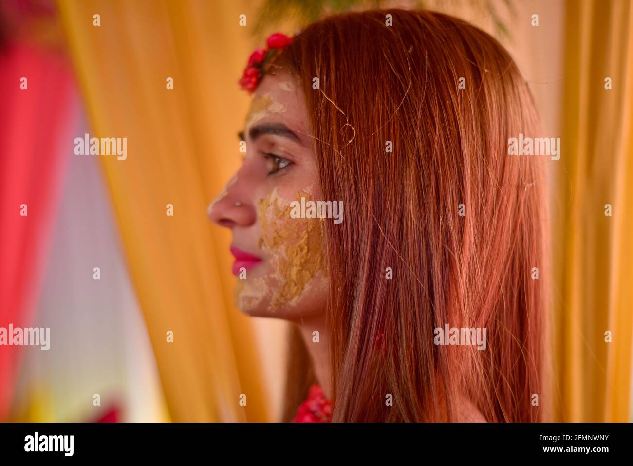 portrait of beautiful indian bride with turmeric haldi paste on her face. Stock Photo