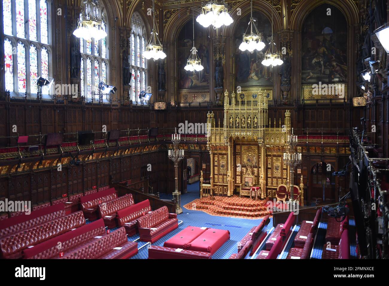 The House of Lords chamber before Queen Elizabeth II delivered a speech from the throne at the Palace of Westminster in London as she outlines the government's legislative programme for the coming session during the State Opening of Parliament. Picture date: Tuesday May 11, 2021. Stock Photo