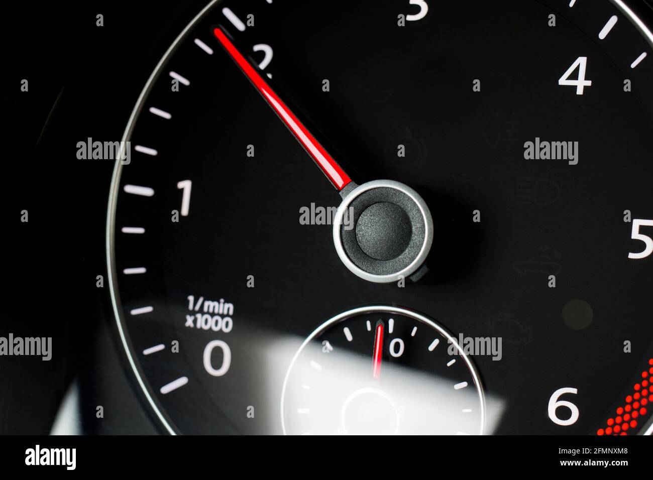 Close-up of a black tachometer in a car - focus on the red needle Stock Photo
