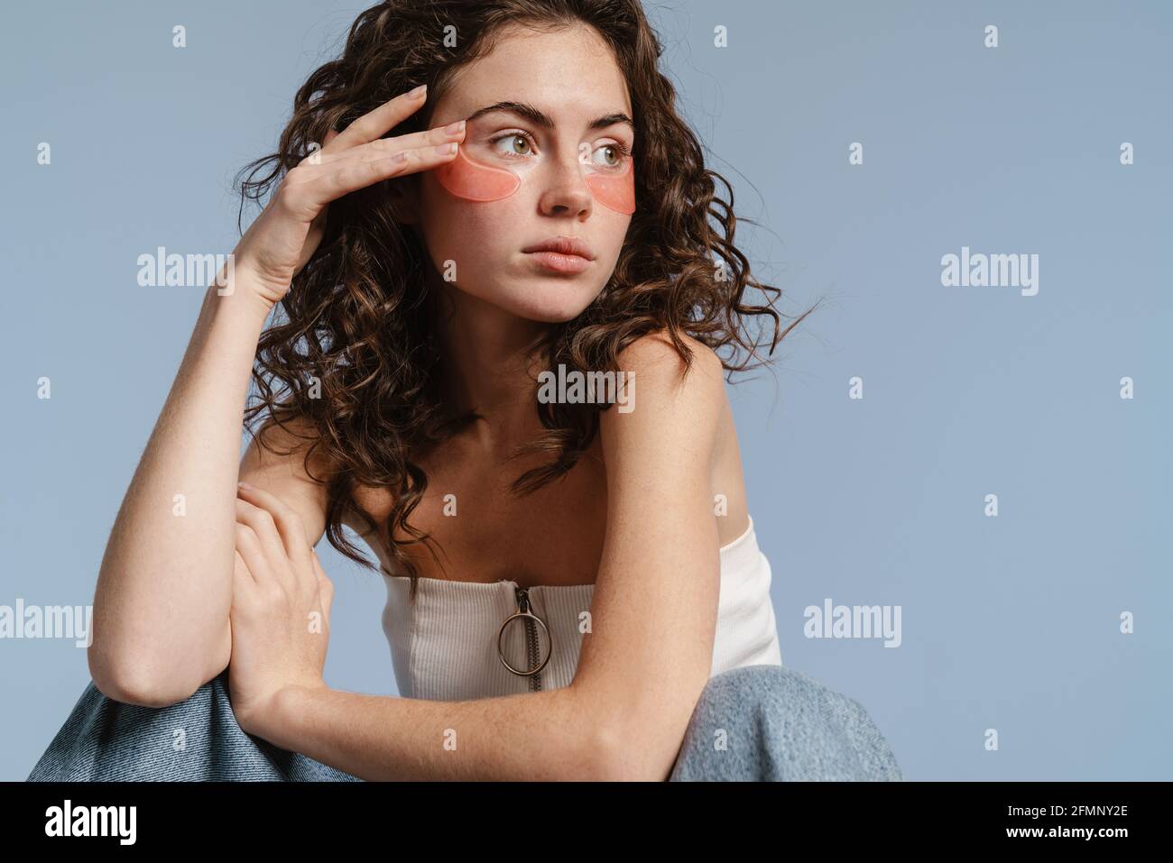 Beautiful caucasian girl with eyes patches posing at camera isolated