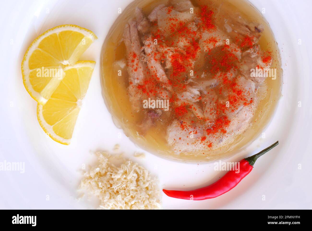 Hungarian pork in jelly, kocsonya, served with slices of lemon, paprika