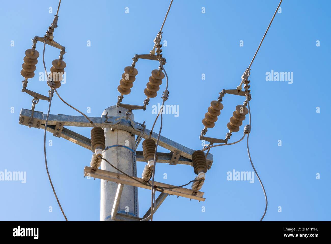 closeup view of mains power line junction with insulator Stock Photo