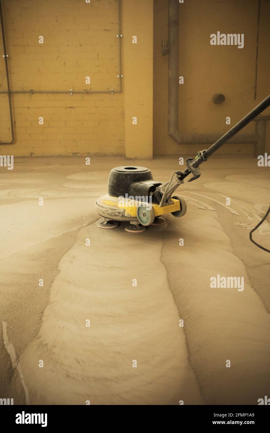 Concrete floor grinding. Construction process. Sanding a concrete floor
