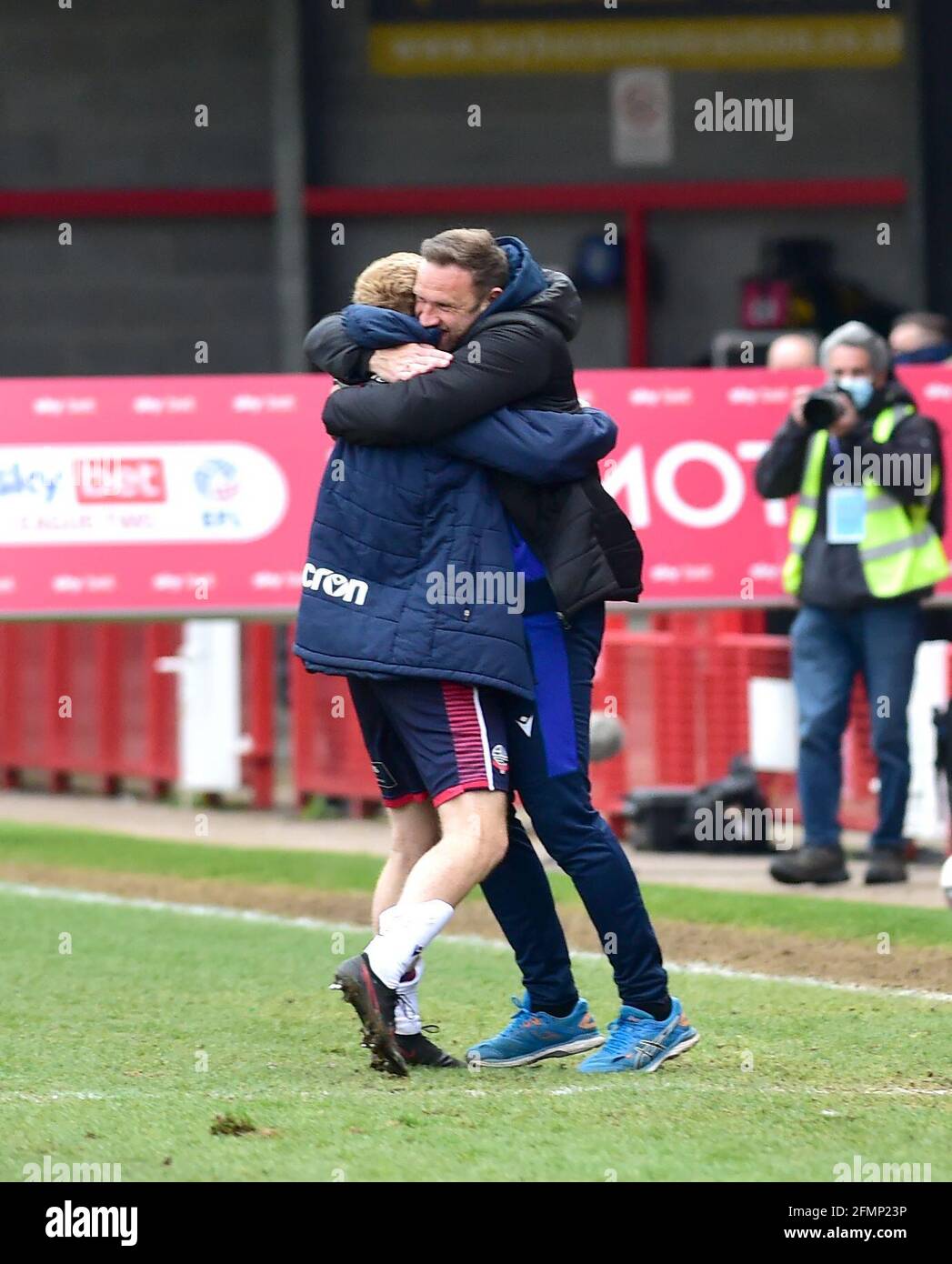 Bolton manager Ian Evatt (rght) celebrates promotion after their win against Crawley in the Sky Bet League Two match between Crawley Town and Bolton Wanderers at the People's Pension Stadium  , Crawley ,  UK - 8th May 2021 -  EDITORIAL USE ONLY No use with unauthorised audio, video, data, fixture lists, club/league logos or “live” services. Online in-match use limited to 120 images, no video emulation. No use in betting, games or single club/league/player publications Stock Photo