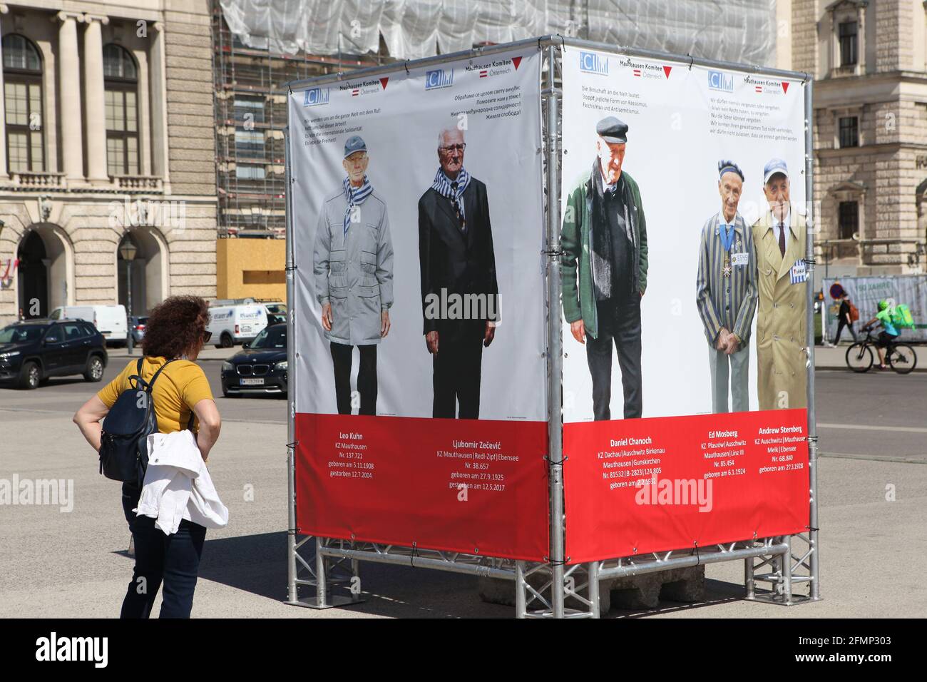 Vienna, Austria. 10th May, 2021. A woman visits the 'Photos of survivors of the extermination camps' exhibition in Heldenplatz, Vienna, Austria, May 10, 2021. An exhibition of 43 life-size photos of survivors of the extermination camps was held here around the Victory in Europe Day. Credit: Wang Zhou/Xinhua/Alamy Live News Stock Photo