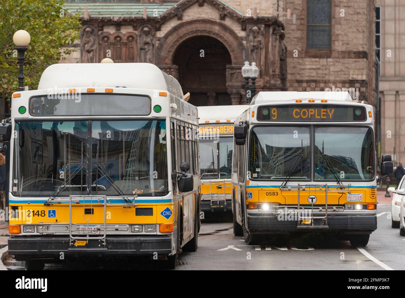 Three MBTA Buses at the Copley Square Bus and Coach Station In Front of Trinity Church on St James Ave in Boston, USA Stock Photo