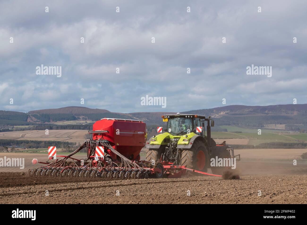 A Claas Axion 940 Tractor and a Horsch Pronto DC Universal Seed Drill Working in a Field in Aberdeenshire in Spring Stock Photo