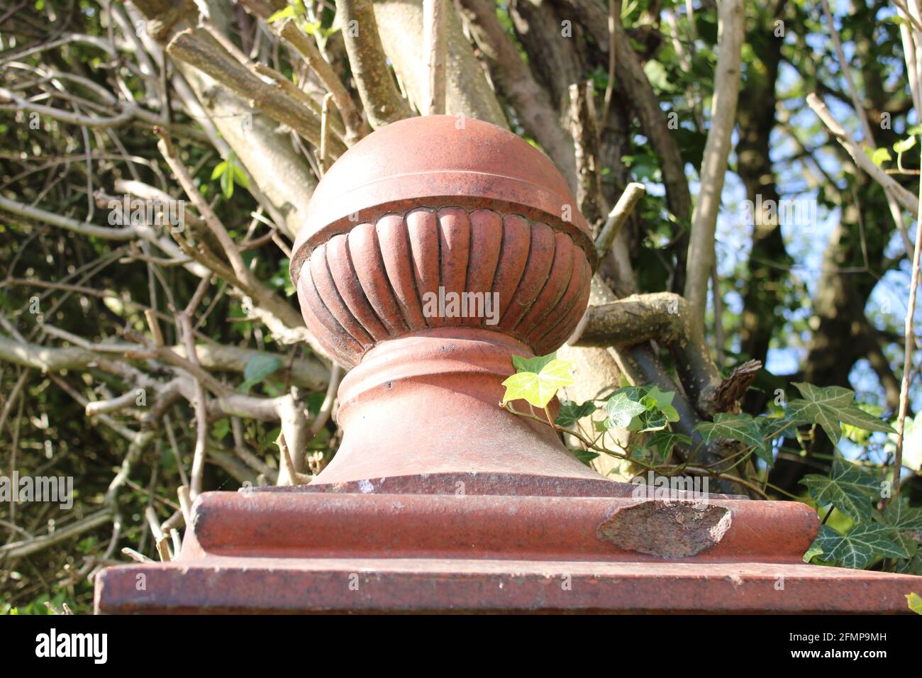 Weathered vintage terracotta gate post finials with interesting pattern and a dark patina to the clay. Stock Photo