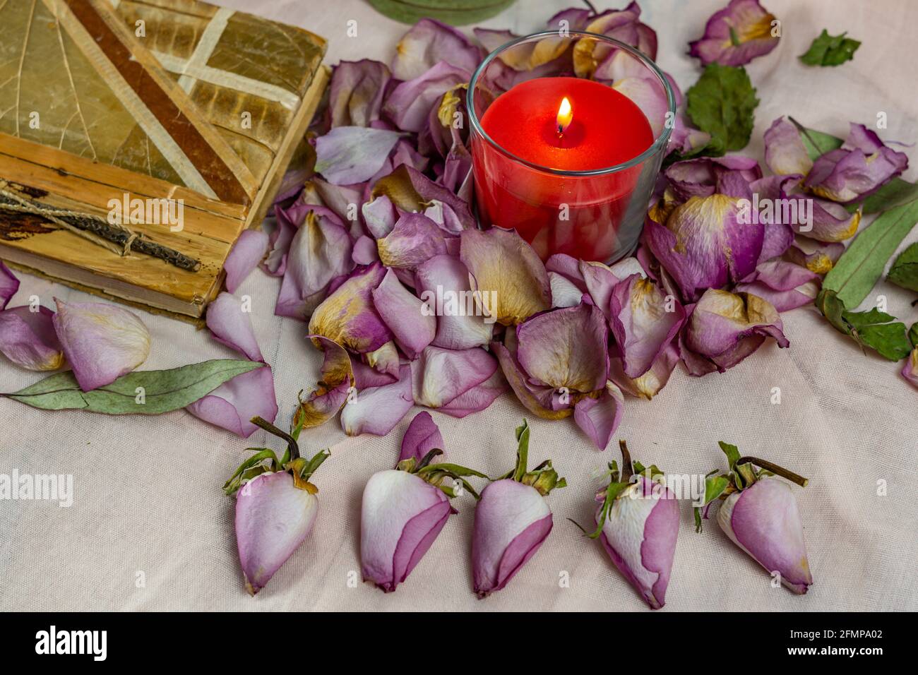 dried roses, candle and book Stock Photo Alamy