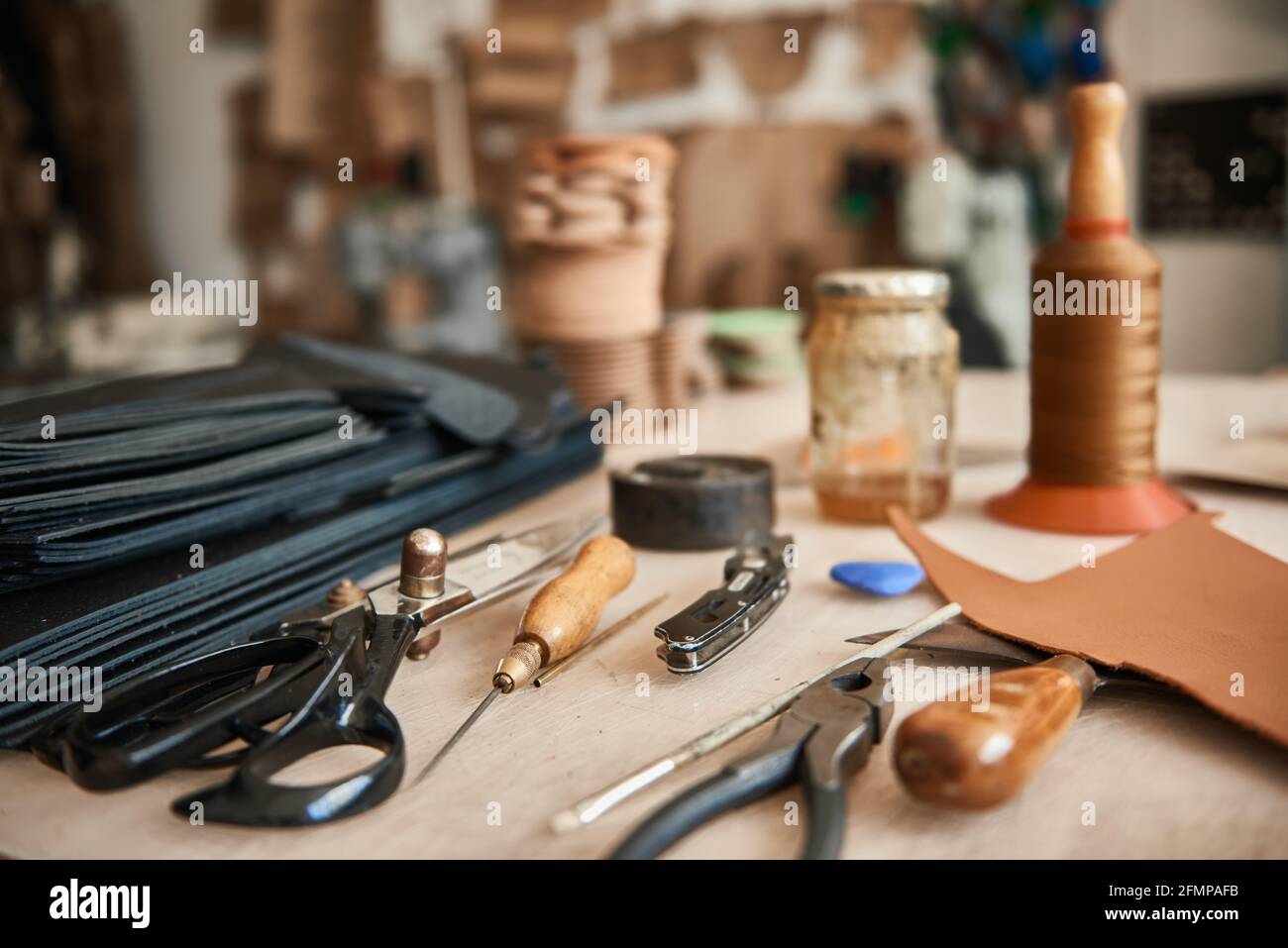Tools sitting on a bench in a leather workshop Stock Photo