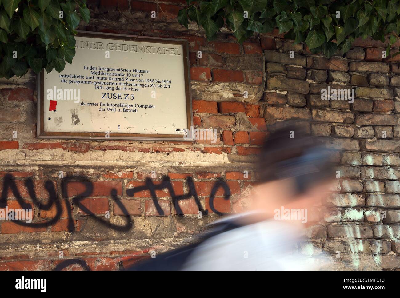 Berlin, Germany. 11th May, 2021. A man walks past the ruins of an apartment building at Methfesselstraße 7 in Berlin-Kreuzberg, where a plaque commemorating the world's first working computer is affixed. In his parents' living room, Konrad Zuse developed a calculating machine that would automatically do the tedious calculations of structural engineers. It was the precursor to the world's first working digital computer. This first functional computer, the Z3, was first put into operation exactly 80 years ago - on 12 May 1941. Credit: Wolfgang Kumm/dpa/Alamy Live News Stock Photo
